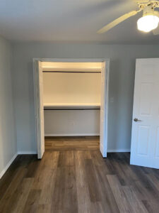 Simplistic hardwood bedroom with great lighting and two closets.