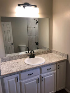 oilet bathtub and vanity area inside the clean bathroom of a home.