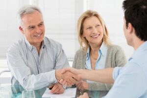 Closeup of male hand pointing where to sign a contract, legal papers or application form.